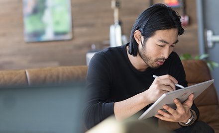 Image of a worker working on a tablet.